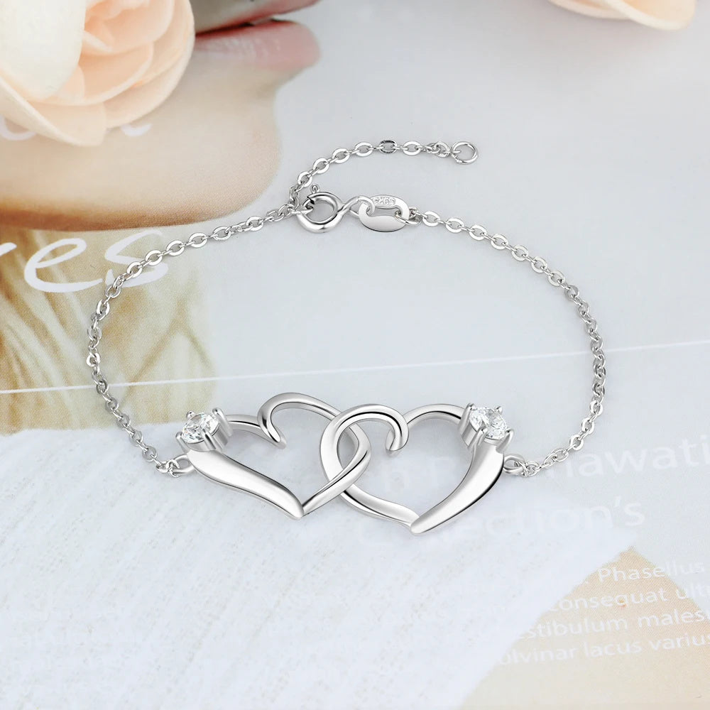 Pulsera de corazón entrelazado de Color plateado con circonita cúbica para mujer